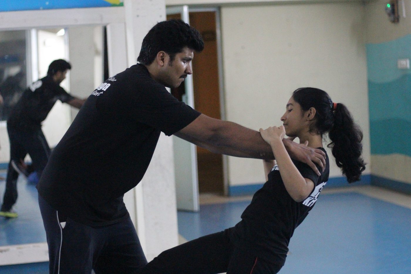 Krav Maga instructor demonstrating a self-defence technique with a student during a class