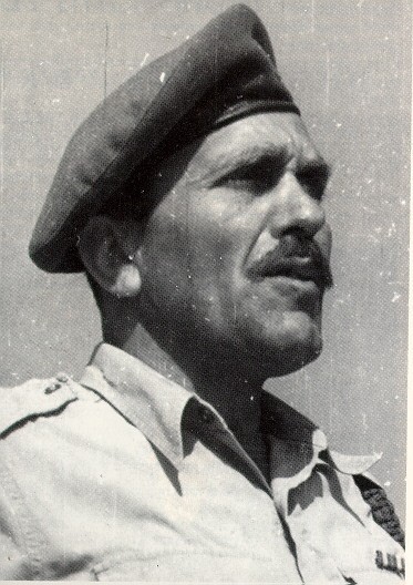 Black and white portrait of Imi Lichtenfeld, the founder of Krav Maga, in a beret and military shirt