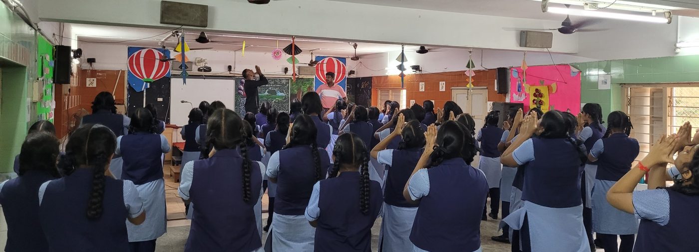 Krav Maga instructor leading school students, seen from behind, in a self-defence session